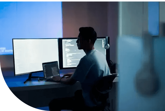 Developer working at a multi-monitor desk